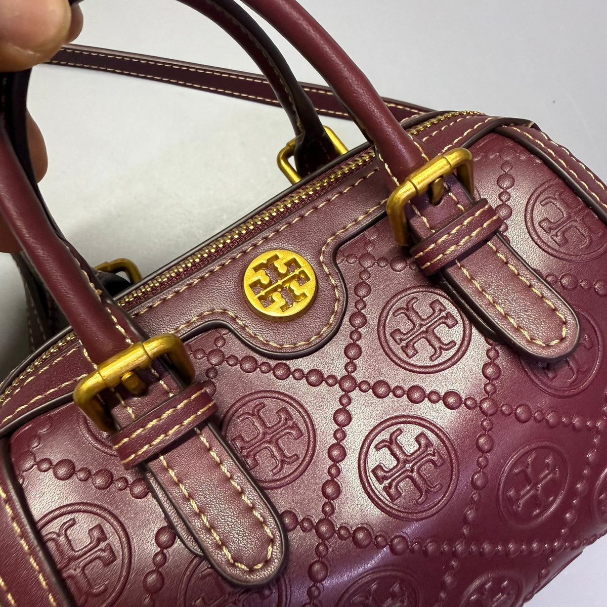 maroon Tory Burch style women's handbag with top handle