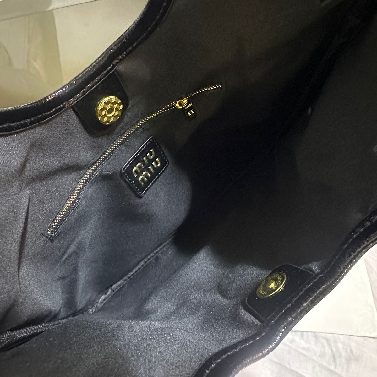 Interior compartment and soft lining view of Miu Miu women shoulder bag