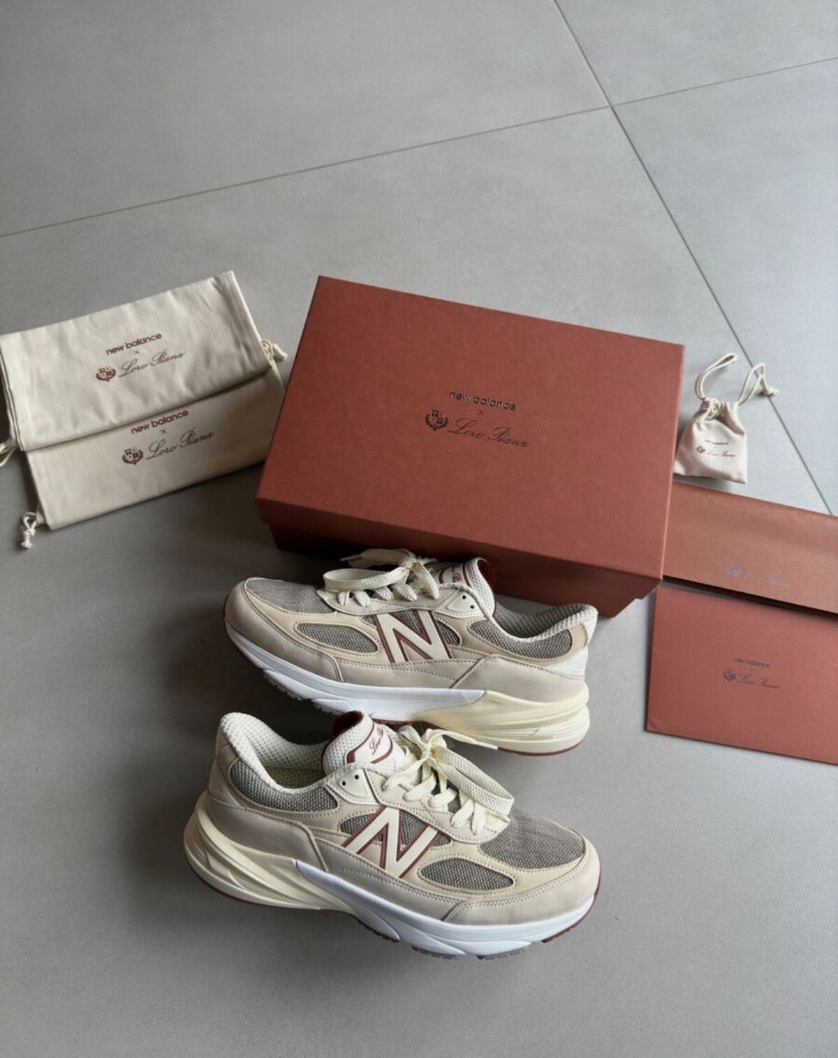 Pair of beige New Balance casual shoes displayed with boxes