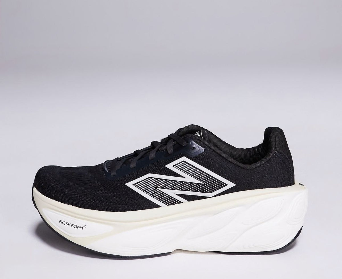 Side profile of black and white New Balance running shoe