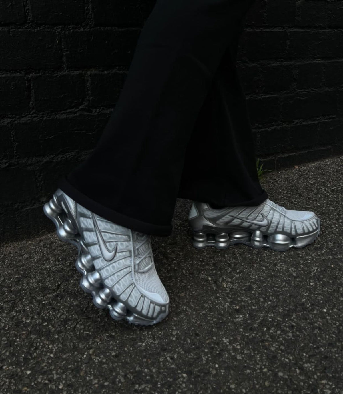 Nike Shox TL White and Metallic Silver sneakers worn on feet