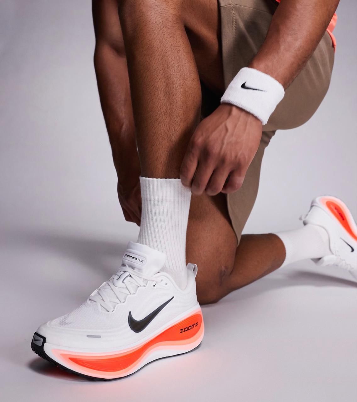Nike Vomero Premium White Bright Crimson unisex sneakers on feet