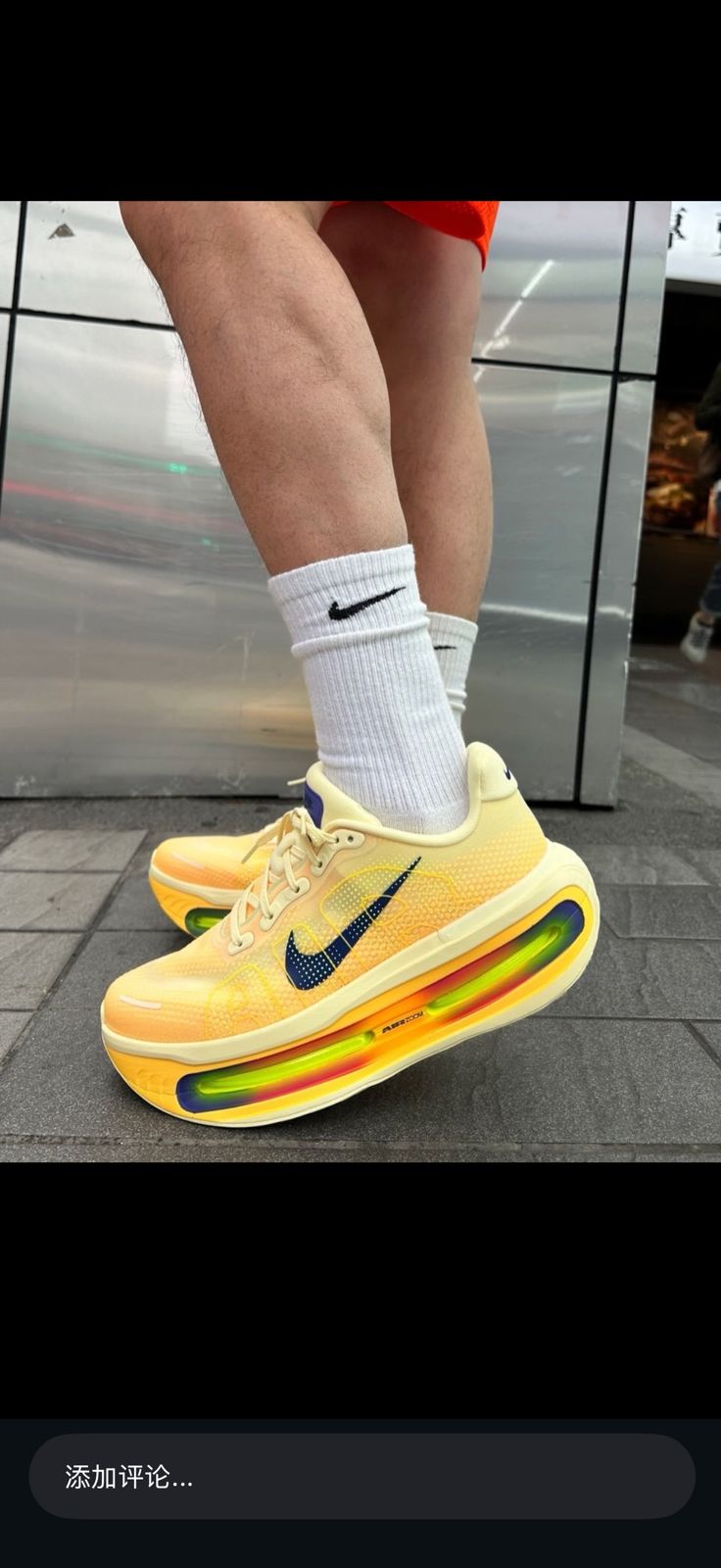 Nike Vomero Premium white orange Lapis running sneakers on feet