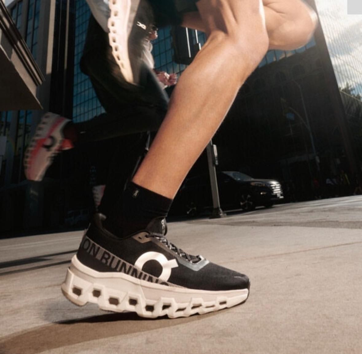 Black and white On Cloud sneakers shown on foot