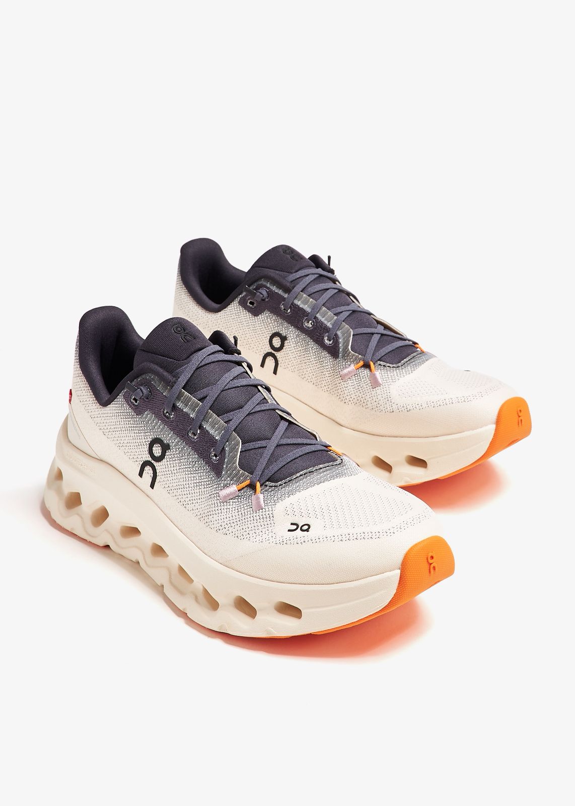 Pair of Ivory Sunstone On Cloudmonster 3 running shoes