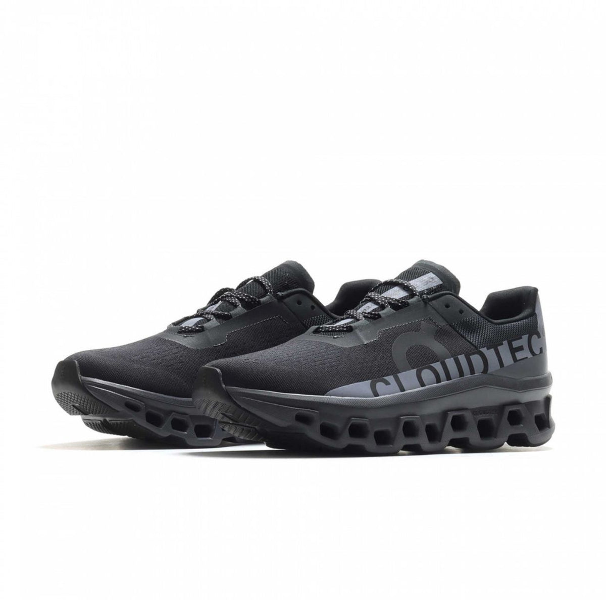Side profile of On Cloudmonster Black Magnet running shoe