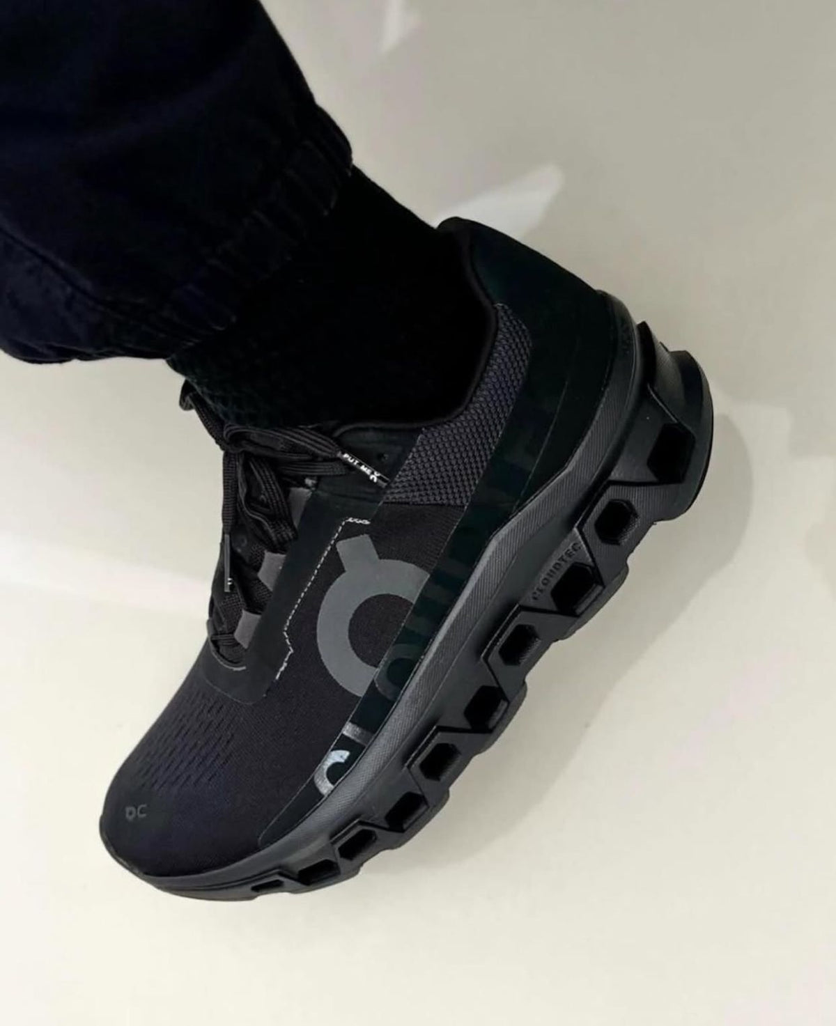 Black On Cloudmonster running shoes shown on foot