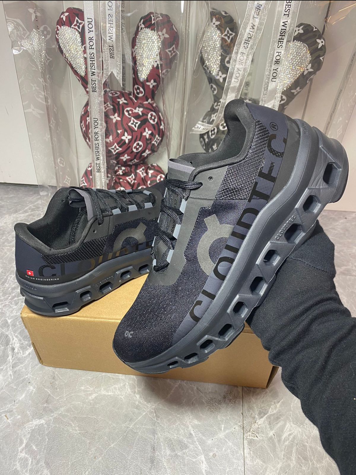 Pair of On Cloudmonster black and grey running shoes