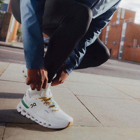 On Cloudrunner 2 white and green sneakers on feet