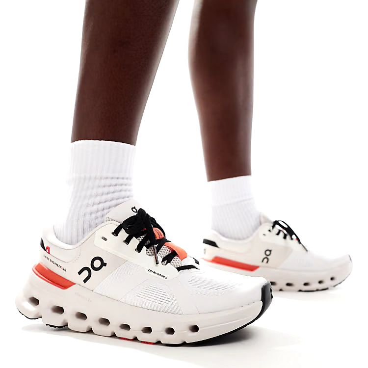 On Cloudrunner 2 white and orange running shoes on feet