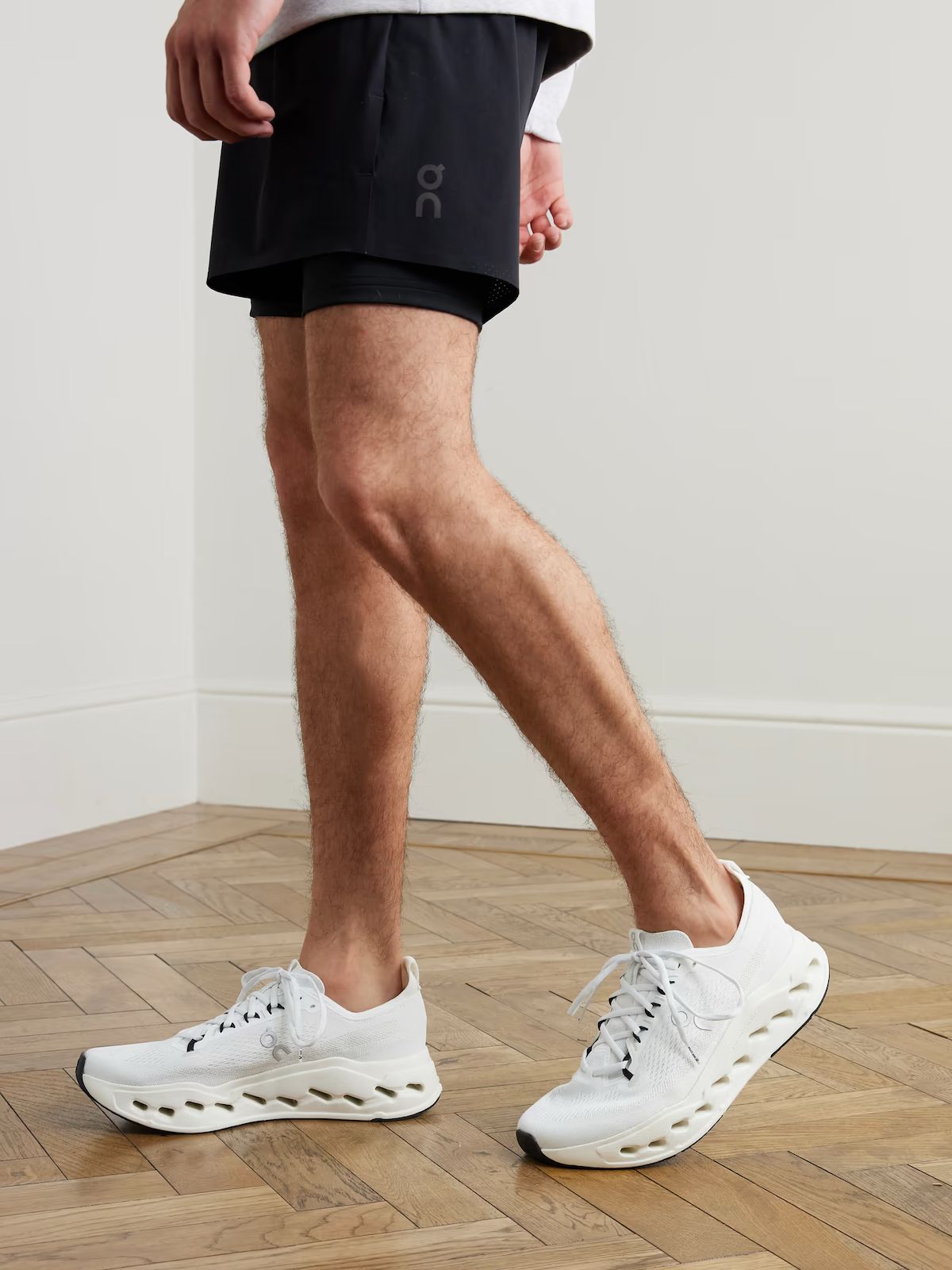 On Cloudsurfer Max white running sneakers on feet