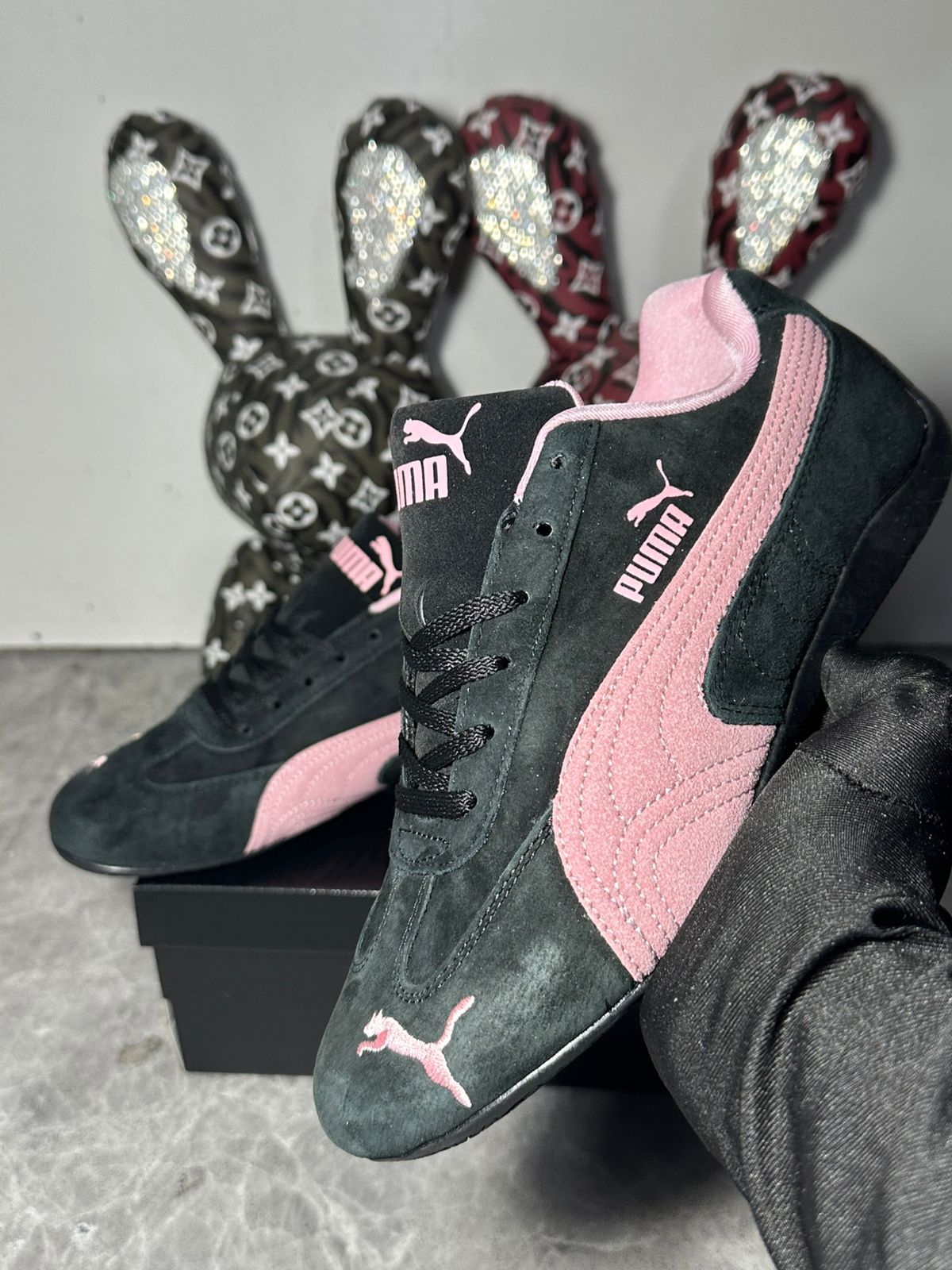 Pair of PUMA Speedcat OG black and pink sneakers