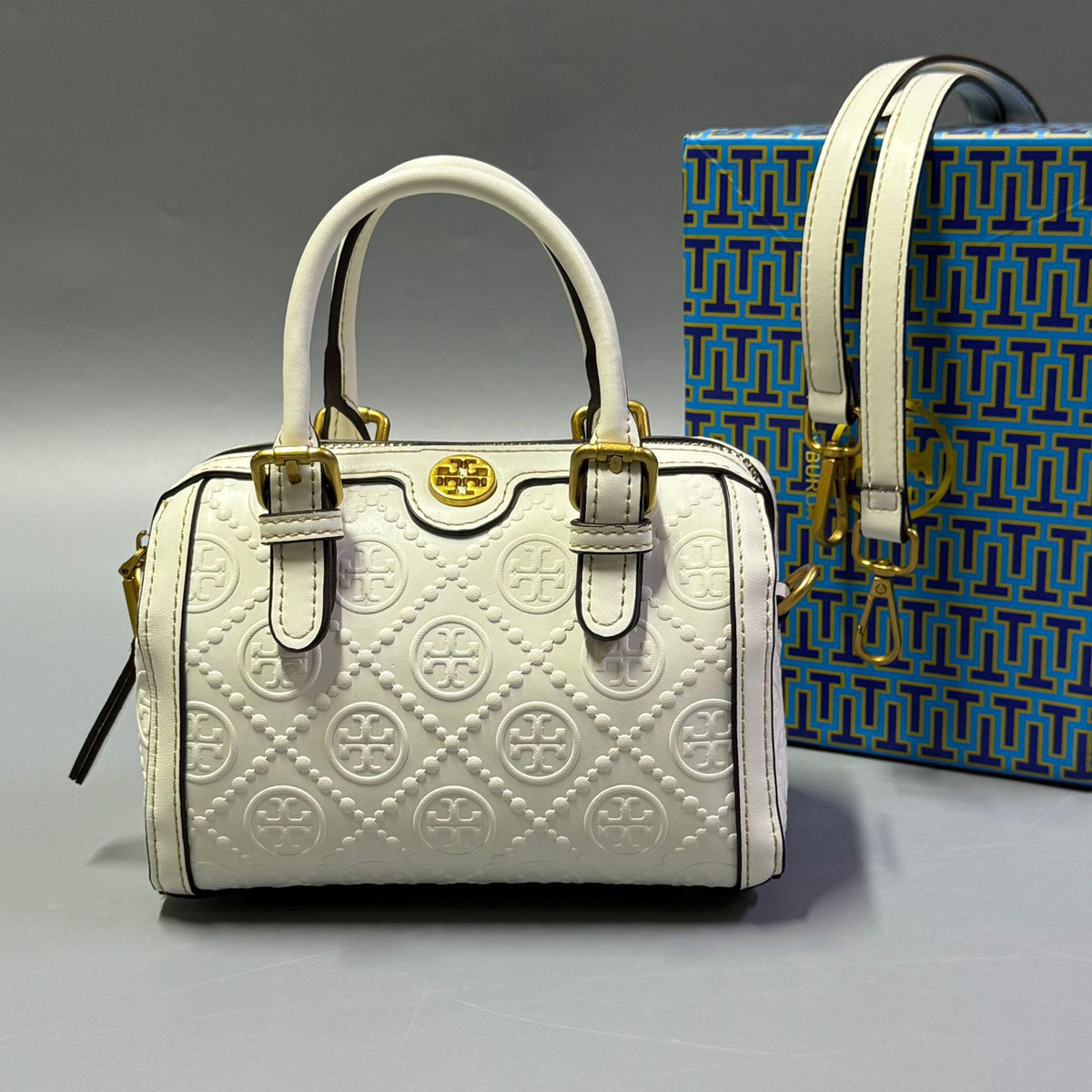White Tory Burch style handbag with elegant gold detailing