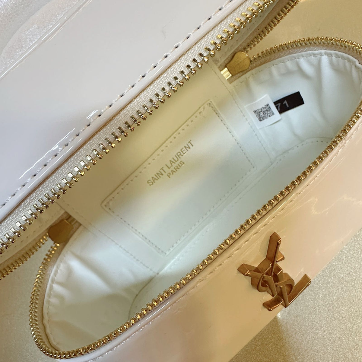 Open interior compartment view of YSL leather vanity handbag